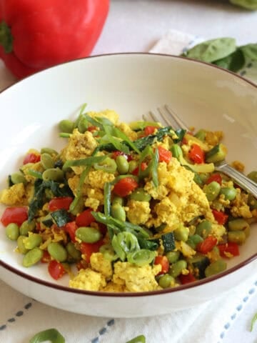 Tofu scramble with zucchini, bell pepper, and edamame.