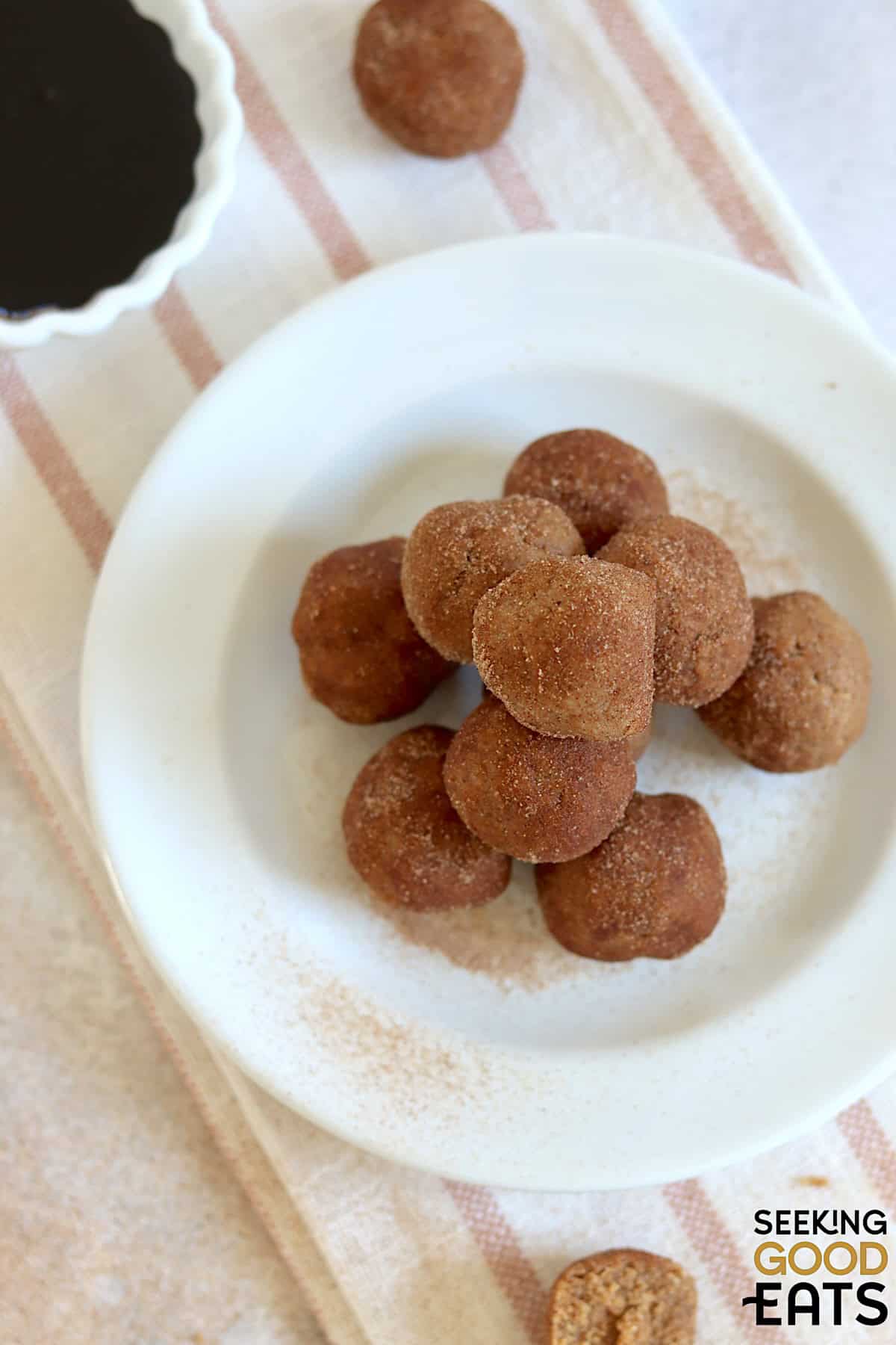 No bake gingerbread protein balls on a white round plate.