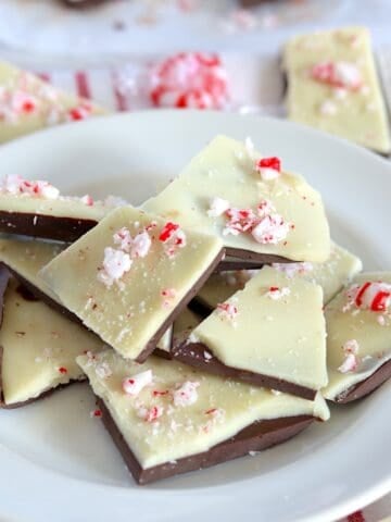 Pieces of sugar free peppermint bark on a white round plate.