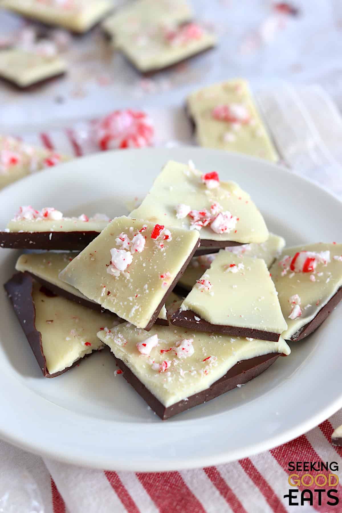 Pieces of sugar free peppermint bark on a white round plate.
