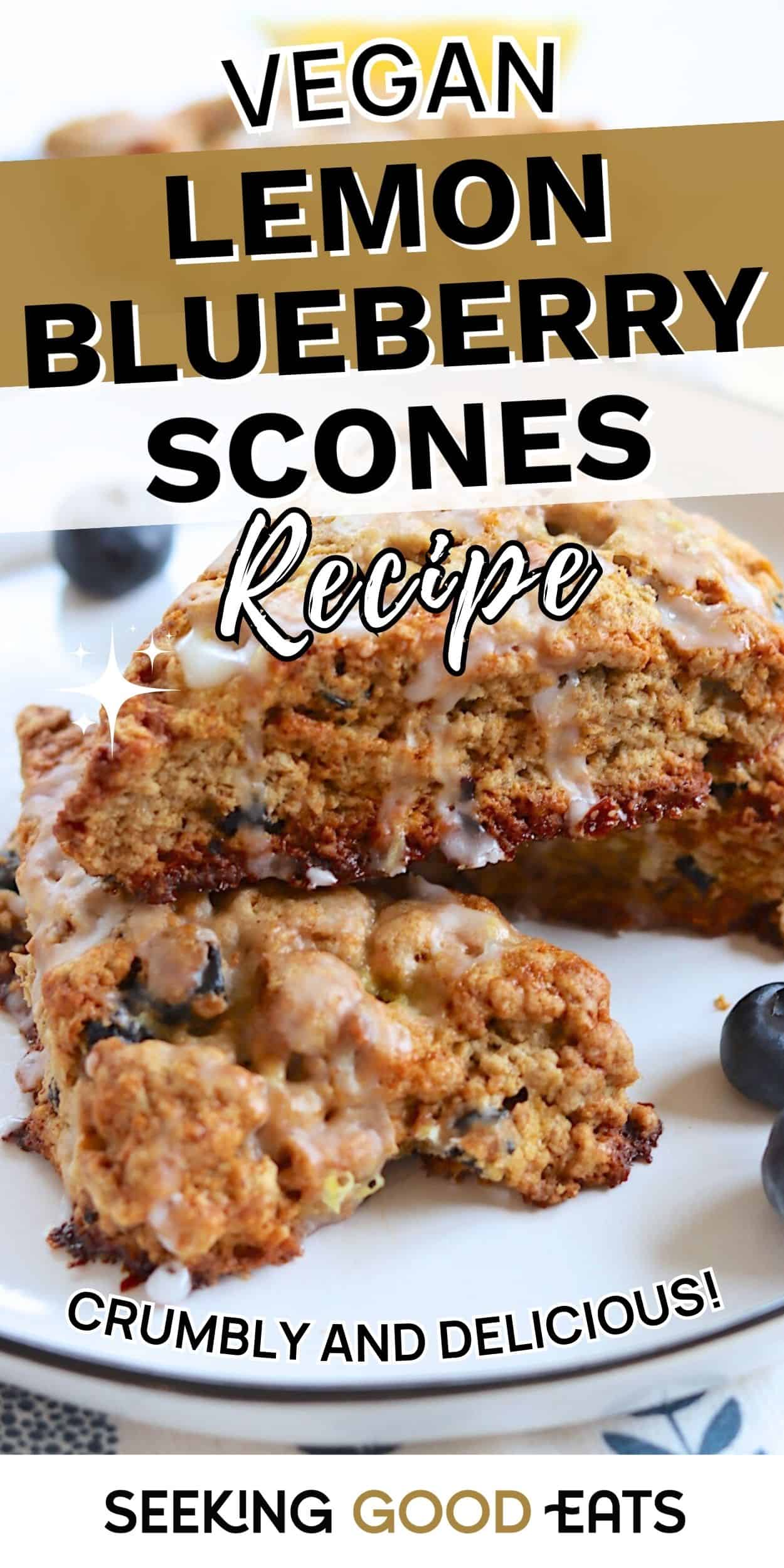 Close-up of vegan lemon blueberry scones stacked on a plate with lemon glaze dripping over the crumbly texture and fresh blueberries nearby.