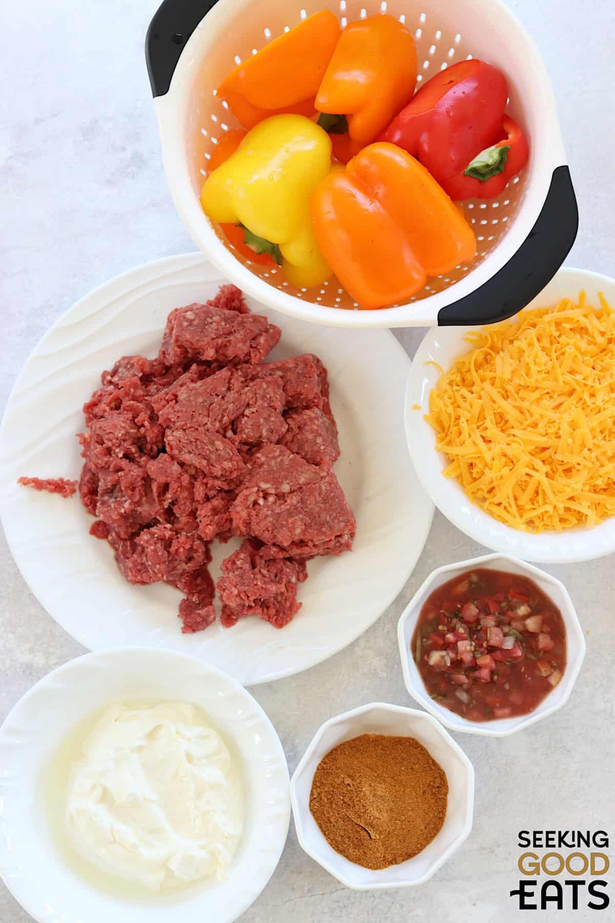 Ingredient needed for making this recipe for taco stuffed peppers on a white board.