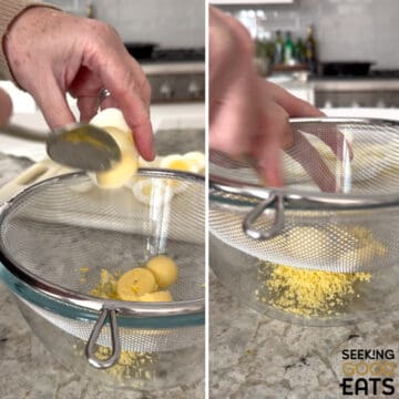Using a mesh strainer, pushing the hard boiled egg yolks through it to make the filling for dill pickle deviled eggs.