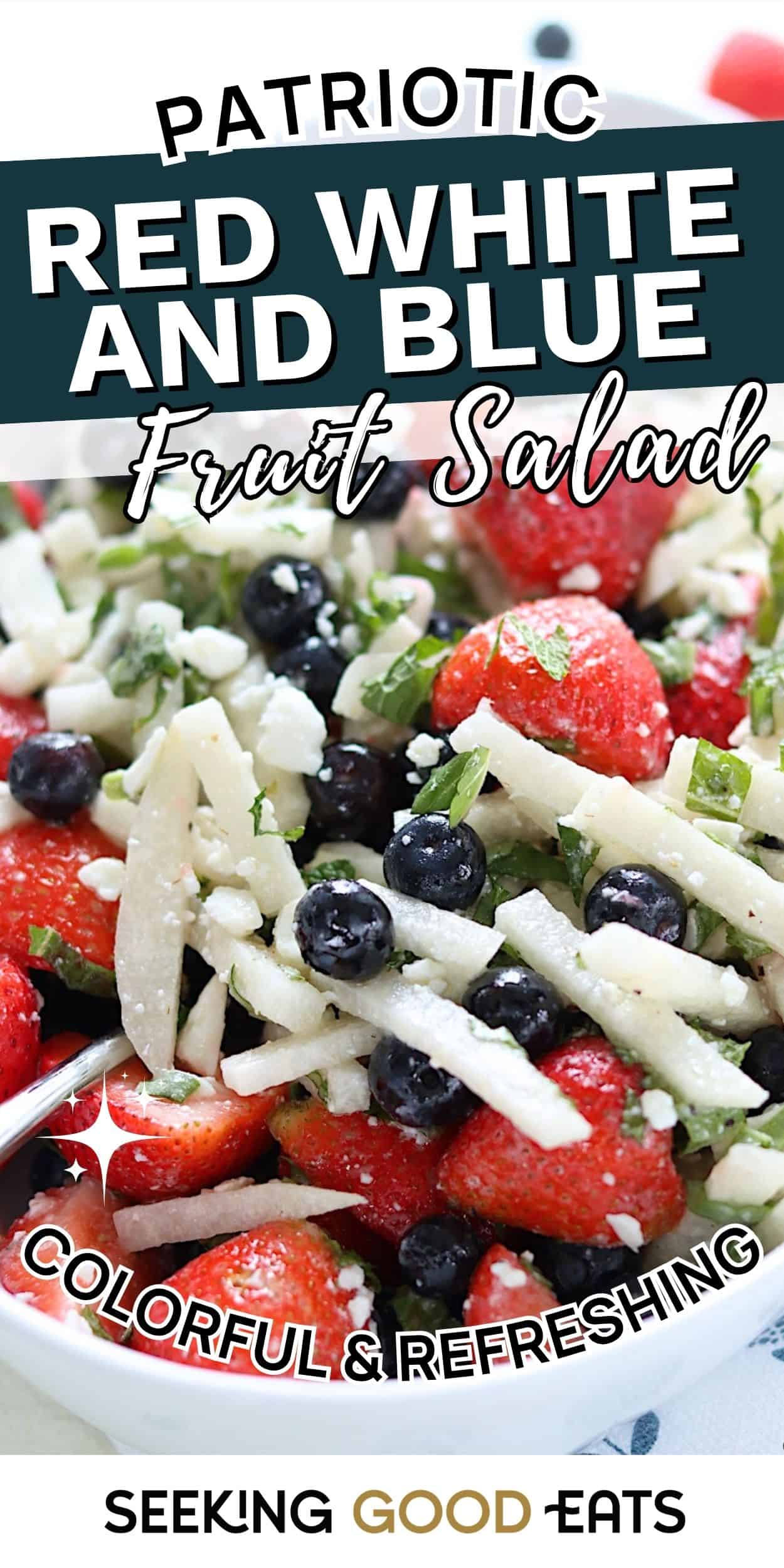 Bowl of red white and blue fruit salad made with strawberries, blueberries, and fresh fruit for a patriotic Fourth of July salad. Colorful and refreshing summer potluck food idea.