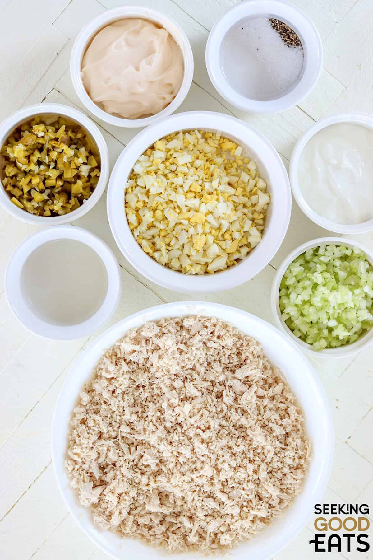 Ingredients needed for making chick fil a chicken salad on a white board.