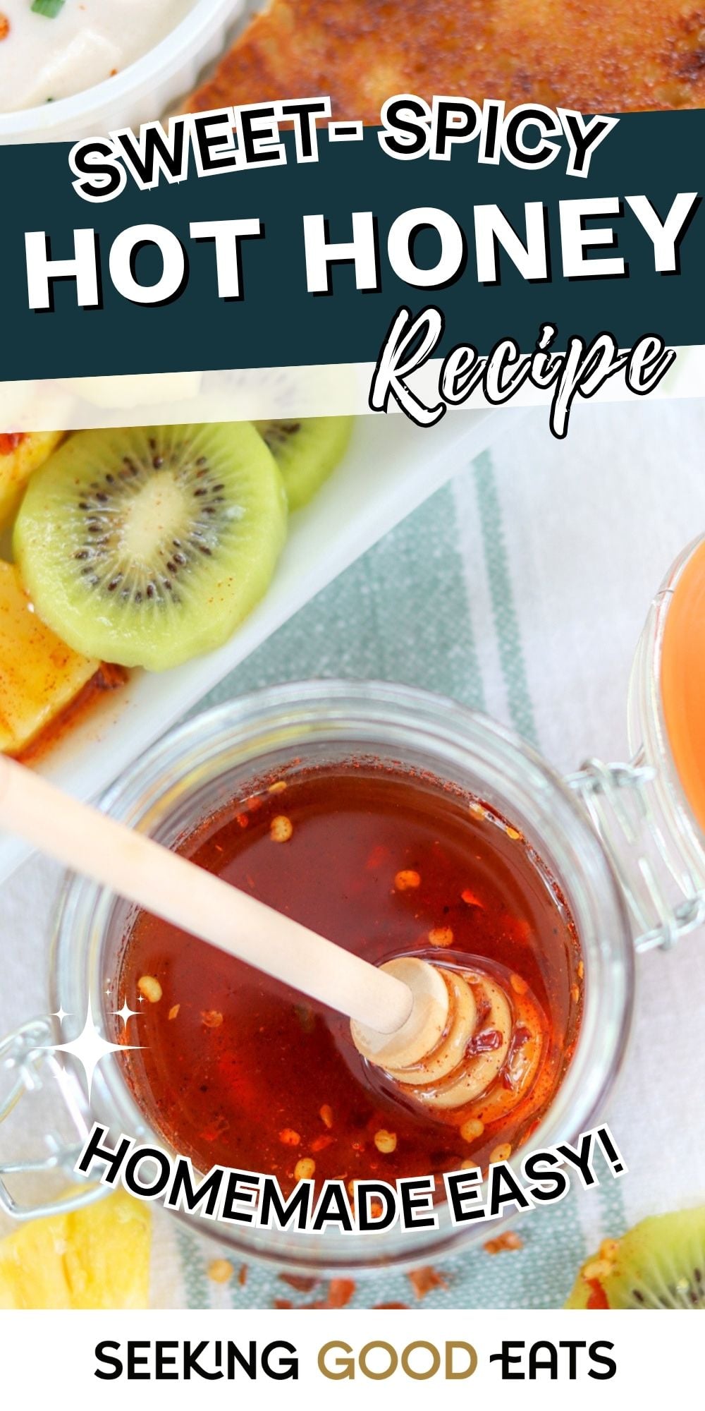 A clear glass jar of homemade hot honey with a spoon for drizzling.