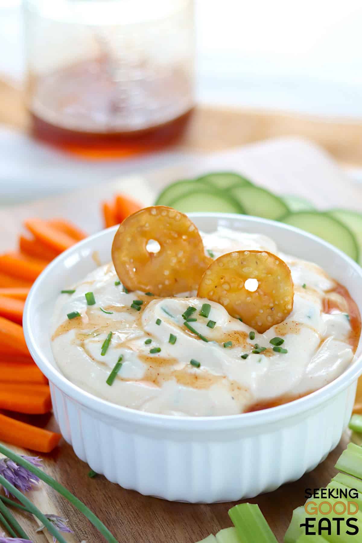 Hot honey whipped cottage cheese with two crackers dipped in a white bowl.