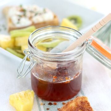 Hot honey in a glass storage jar.
