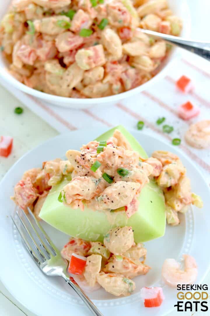 Healthy seafood pasta salad served over melon.