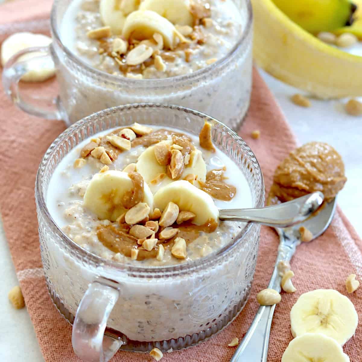 Bananas, peanuts, and peanut butter drizzled over the top of peanut butter banana overnight oats.