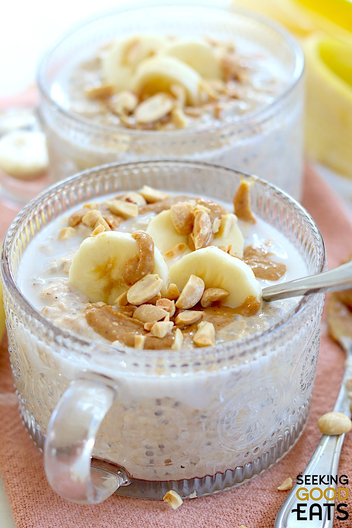 Peanut butter banana overnight oats in a two clear decorative bowls.
