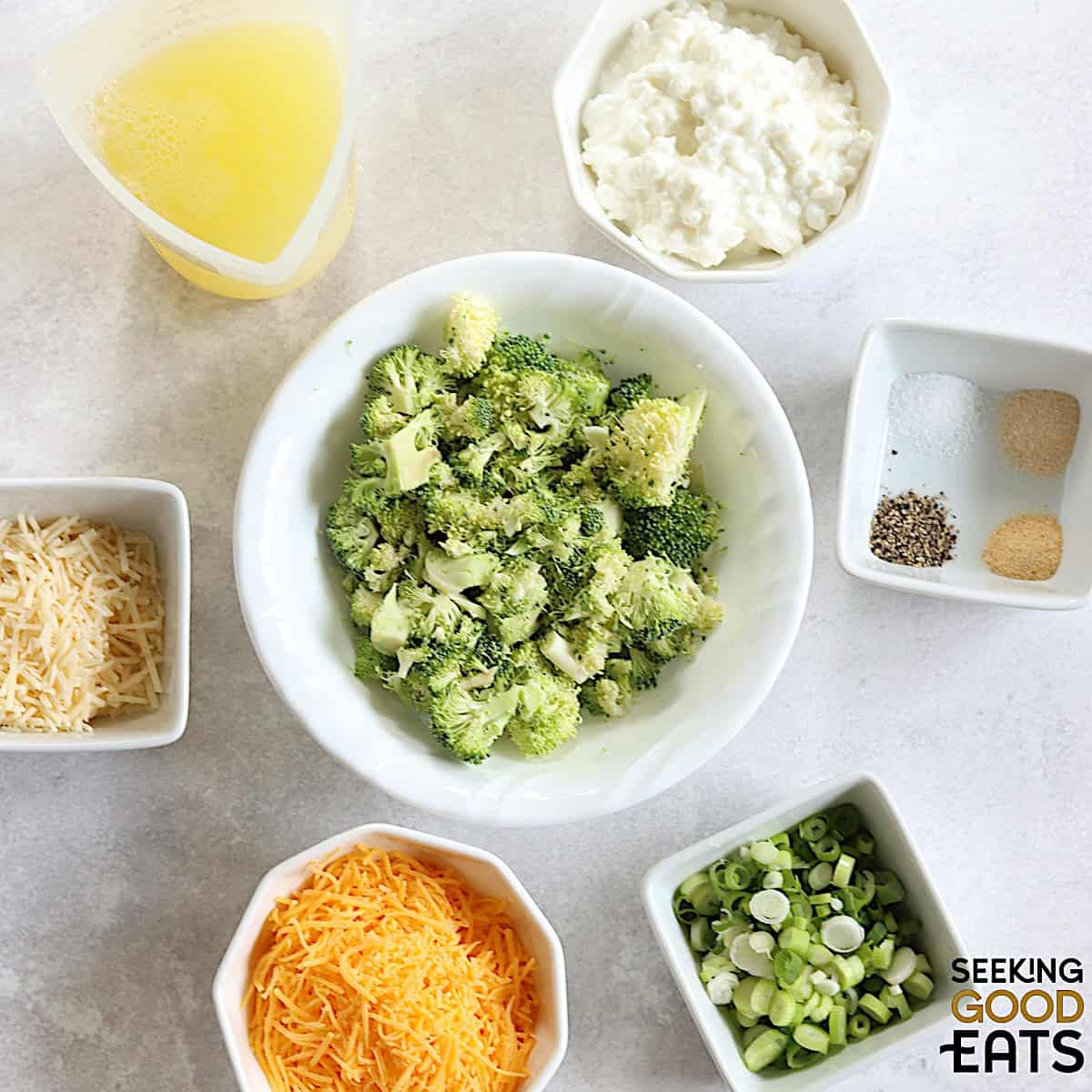 Ingredients needed for making broccoli cheddar egg bites on a white board.