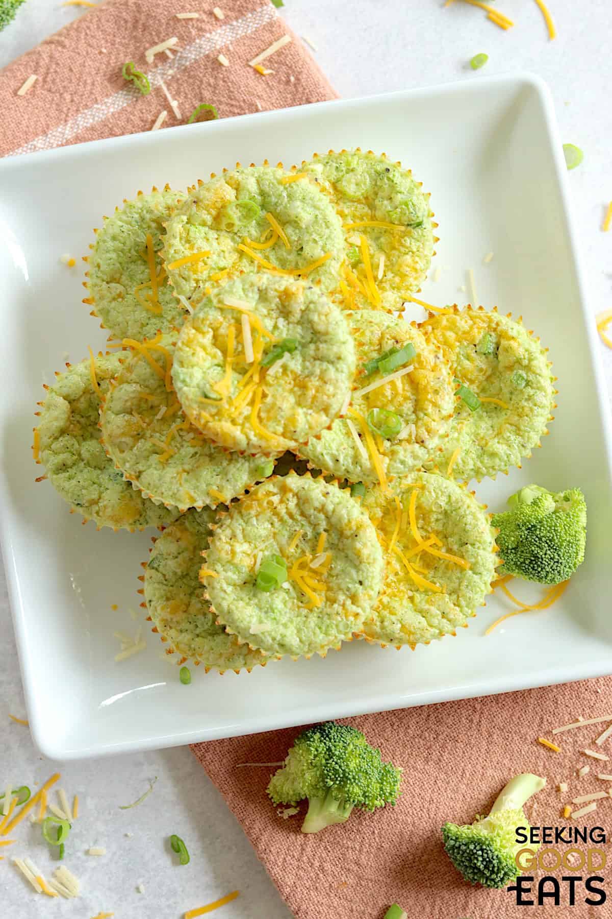 A square white plate with personal size broccoli cheddar egg bites on a white plate.